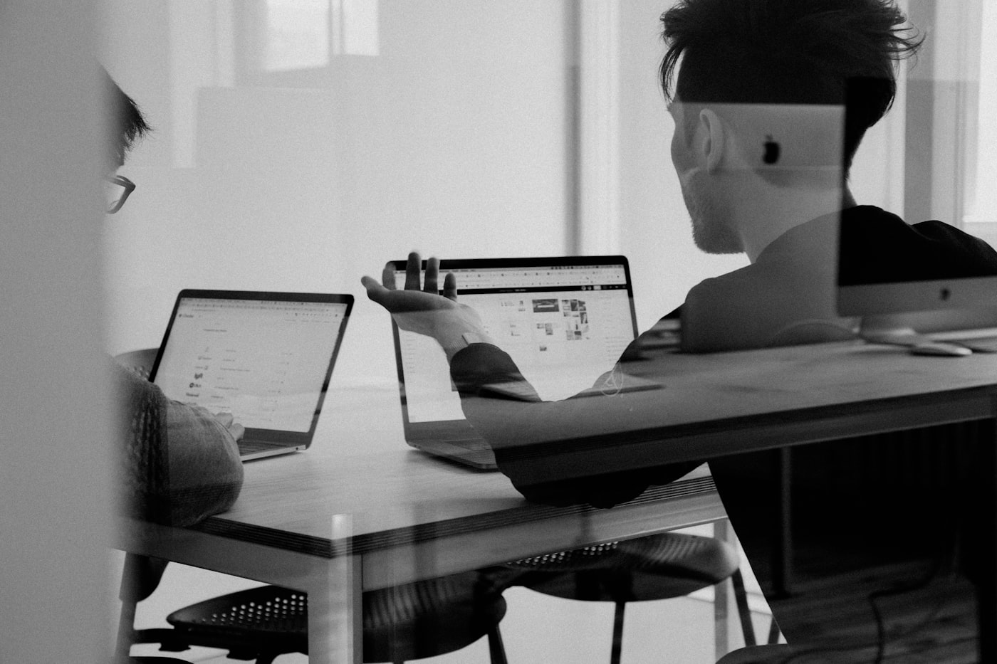 Product team gathered around a table during a user research synthesis session